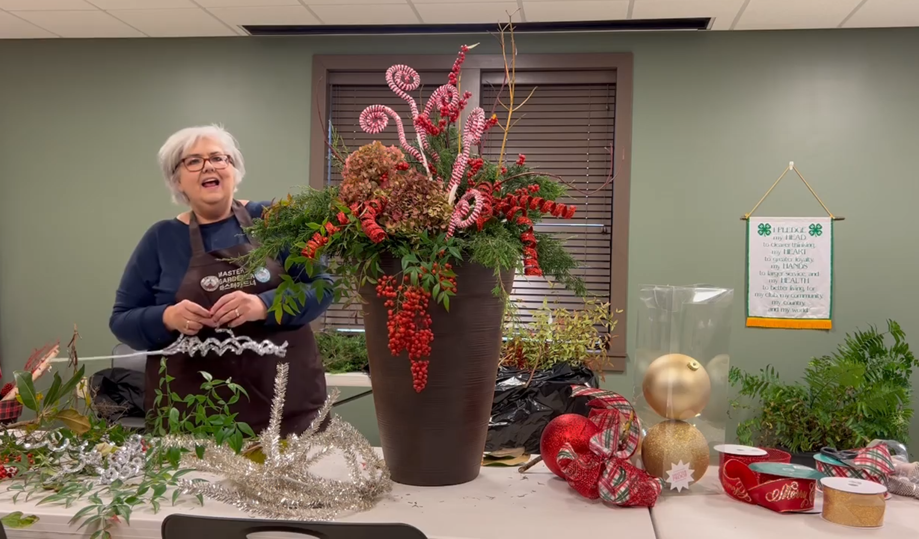 Woman demonstrating how to arrange flowers