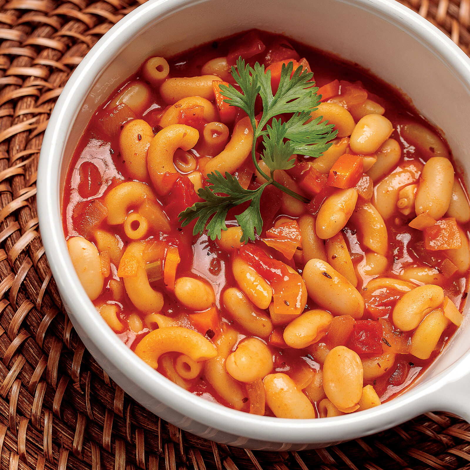 A bowl of soup with macaroni and beans