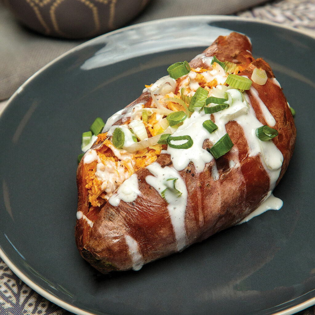 A roasted sweet potato with toppings
