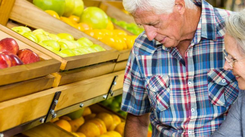 Elderly couple looking at produce